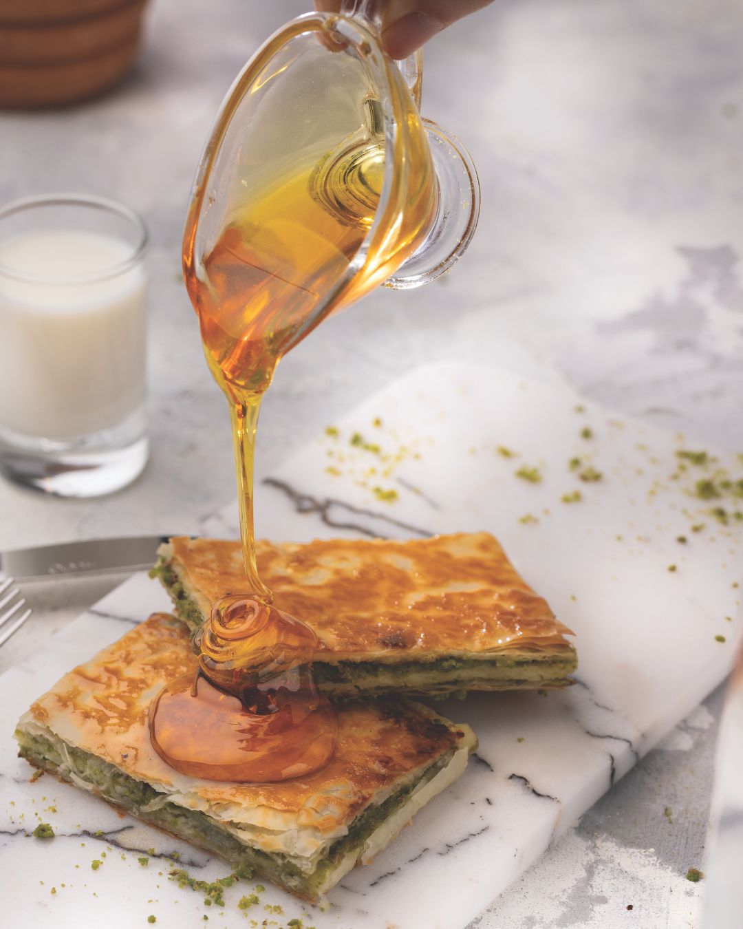 Syrup poured over pistachio baklava pastry