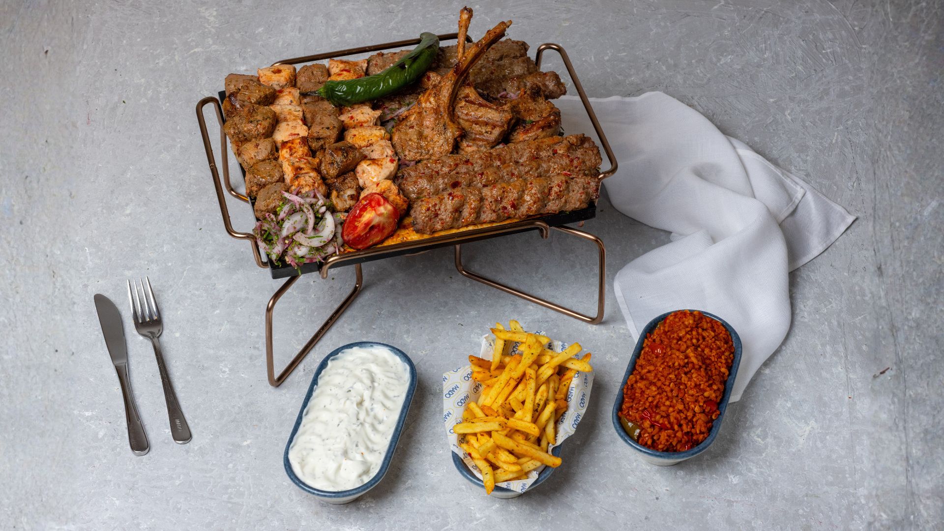 Turkish mixed grill platter with lamb chops, kebabs, fries and bulgur